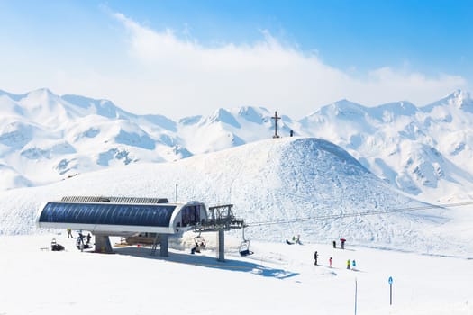 Skiers on ski lift the ski slopes in  Alp mountains, Triglav natural park, Vogel, Bohinj, Slovenia.