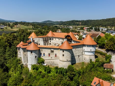 Aerial drone view of Medieval castle of Zuzemberk or Seisenburg or Sosenberch, positioned on terrace above the Krka River Canyon, Central Slovenia