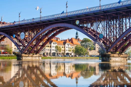 Old Bridge and Lent district in Maribor, Slovenia. Popular waterfront promenade with historical buildings and the oldest grape vine in Europe
