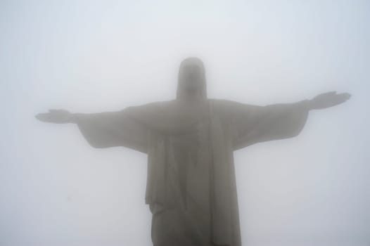 Rio de Janeiro, Brazil - September 14, 2019.  Redeemer Christ statue on Corcovado hill covered with fog..