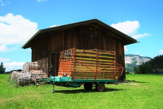 Wooden shed on a meadow under a blue sky