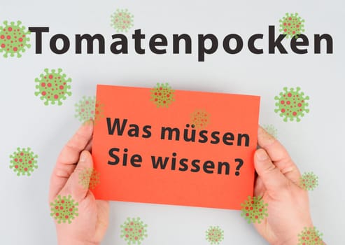 The words tomato pox, what you need to know, are standing in german language on a paper, outbreak of the virus in India, infectious disease spreading