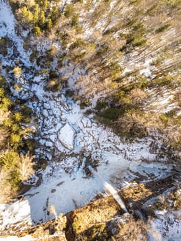Aerial view of Pericnik slap or Pericnik Waterfall in winter time, Triglav National Park, Slovenia. Upper and lower waterfalls cascading over a rocky cliff, reachable by a picturesque walking trail