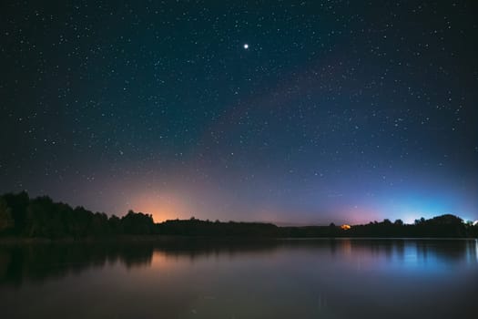 Village Novoye Lyadno, Lyepyel District, Vitebsk Province, Belarus. Real Colorful Night Stars Above Lepel Lake. Natural Starry Sky Background Backdrop Landscape.