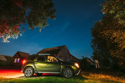Suv dirty Car Parking On Street Under Night Starry Sky. Russian Village.