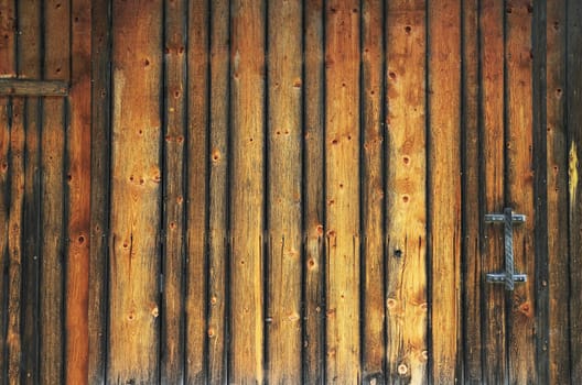Wooden wall under a blue sky in summer