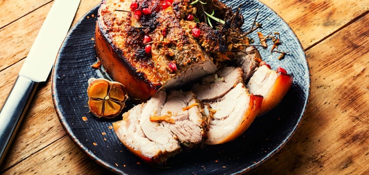 Tasty fried pork belly with spices and herbs. Fatty piece of meat. Copy space