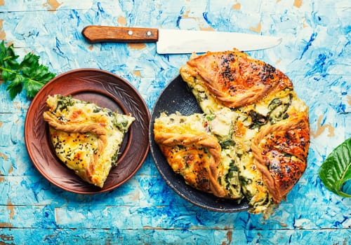 Homemade pie with cheese and herbs. Pie with soft cheese filling.