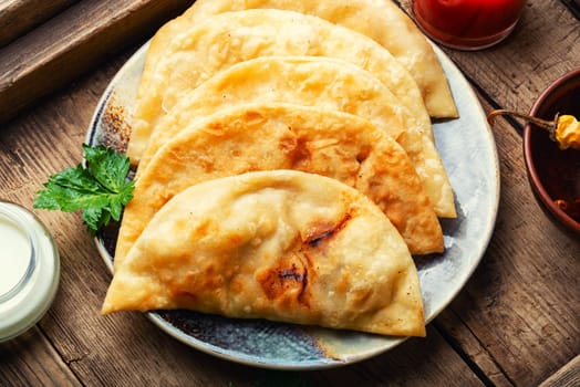 Chebureks making yeast dough, stuffing with minced beef
