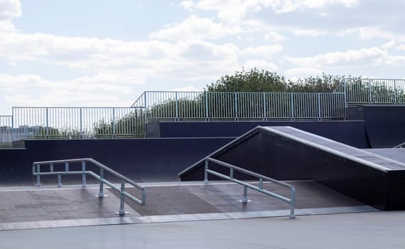 Skate park during the day. Empty, no people skating park. Skatepark ramps