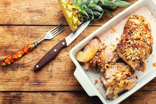 Pork meat baked with pineapple and cheese
