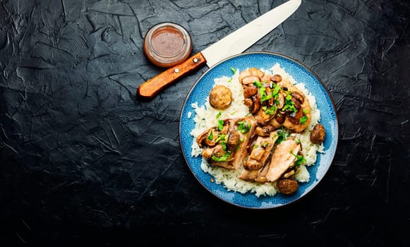 Baked chicken breast with marsala mushroom sauce and rice.