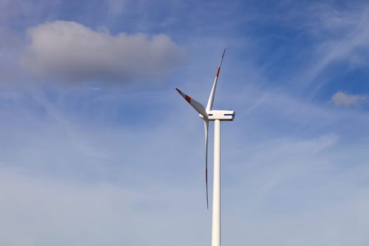 white wind turbine in the top of the mountain