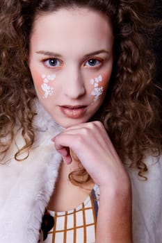 young beautiful woman close up portrait with painted face