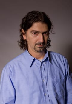 young casual man portrait in a dark background
