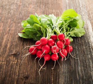 Bunch of fresh red radish on wooden table