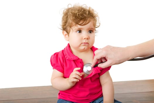 doctor with happy baby making examination