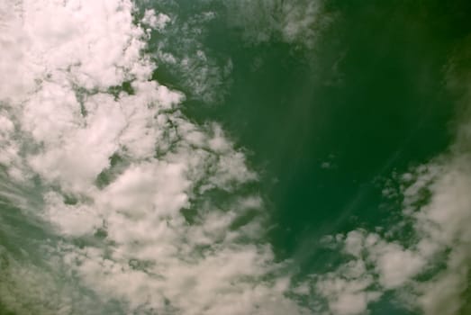 The soft white clouds against blue sky