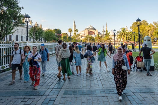 Istanbul, Turkey - August 5, 2022: People People in Sultan Ahmed park walking to Hagia Sophia Camii mosque or Ayasofya in Turkish , Istanbul, Turkey.