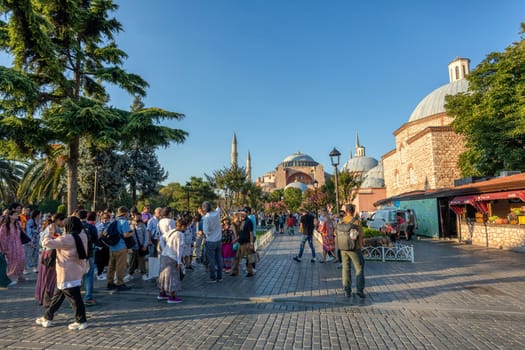 Istanbul, Turkey - August 5, 2022: People People in Sultan Ahmed park walking to Hagia Sophia Camii mosque or Ayasofya in Turkish , Istanbul, Turkey.