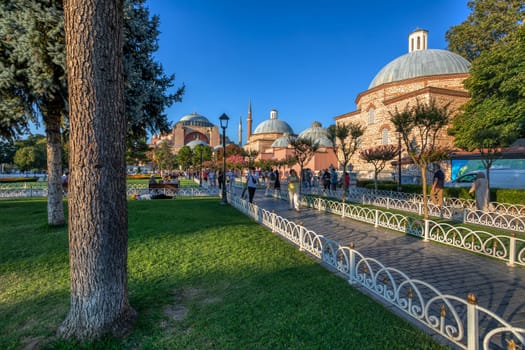 Istanbul, Turkey - August 5, 2022: People People in Sultan Ahmed park walking to Hagia Sophia Camii mosque or Ayasofya in Turkish , Istanbul, Turkey.