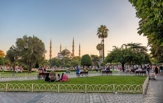 Istanbul, Turkey - August 5, 2022: View of people resting in Sultan Ahmed Blue Mosque park Istanbul, Turkey