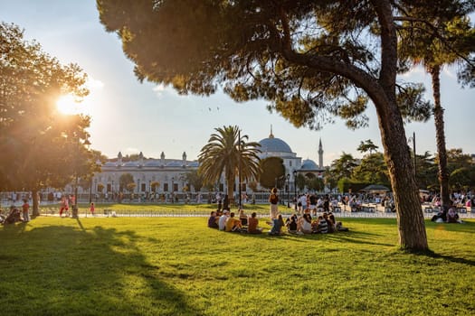 Istanbul, Turkey - August 5, 2022: View of people resting in Sultan Ahmed Blue Mosque park Istanbul, Turkey