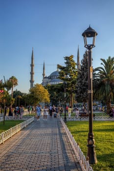 Istanbul, Turkey - August 5, 2022: View of people resting in Sultan Ahmed Blue Mosque park Istanbul, Turkey