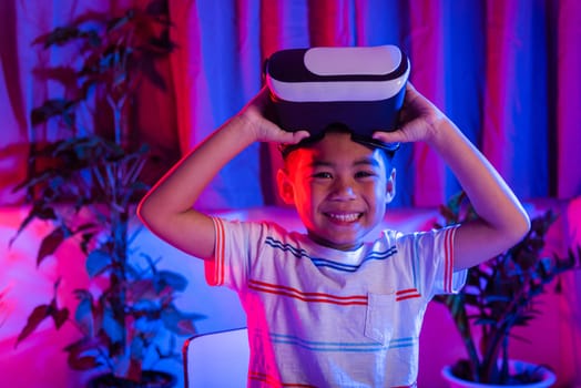 Little kid boy experiencing virtual reality goggles experiencing reality, Child open VR helmet glasses from eyes excited and smiling purple and blue background, Virtual technology