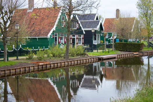 Traditional Houses reflecting in the Canal in the Historic Village of Zaanse Schans on the Zaan River in the Netherlands