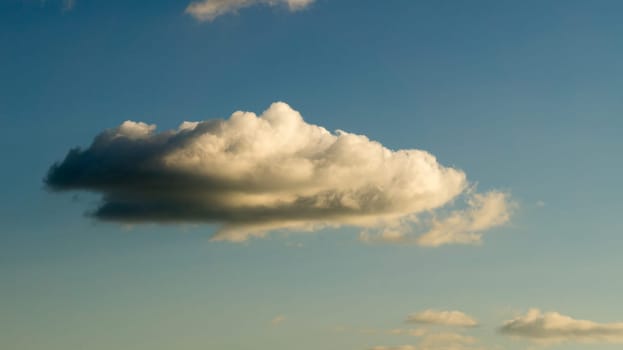 Clouds illuminated by the sun in the sky as background. Background image for further editing