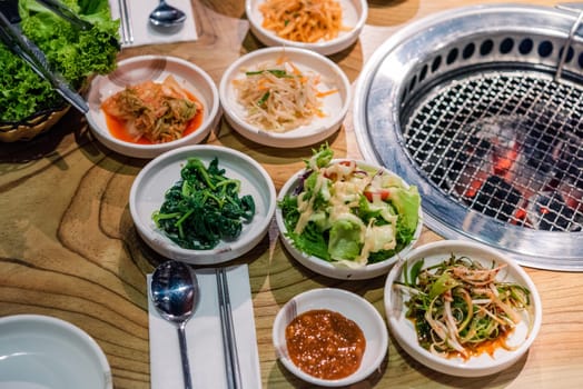 Spicy Kimchi group. Korean pickle or Pickled radish vegetables set and seasoning on bowl on stove serve wood table background, Japanese food