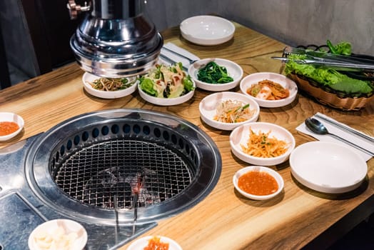 Spicy Kimchi group. Korean pickle or Pickled radish vegetables set and seasoning on bowl on stove serve wood table background, Japanese food