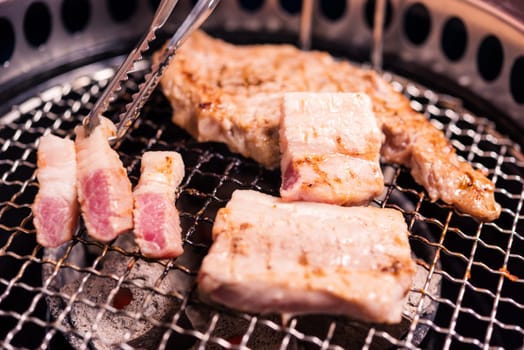Korean beef barbecue on hot coals. Grilling meat pork Korean BBQ traditional style on stove serve in restaurant, Japanese food