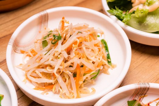 Spicy Kimchi. Korean pickle or Pickled radish vegetables and seasoning on bowl on wood table background, Japanese food