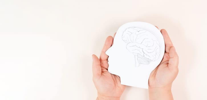 Holding a head with a brain in the hands, Parkinson disease, Alzheimer awardness, mental disorder dementia, psychology problems, cerebral vein thrombosis