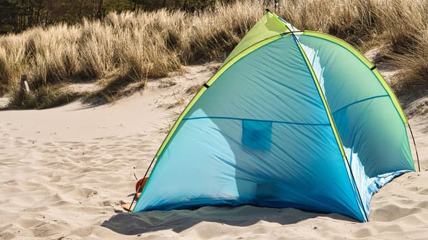 a tent for wind protection on the beach of the Baltic Sea in summer vacation. before the dunes in the sand in front of the sea. Relaxed vacations in summer
