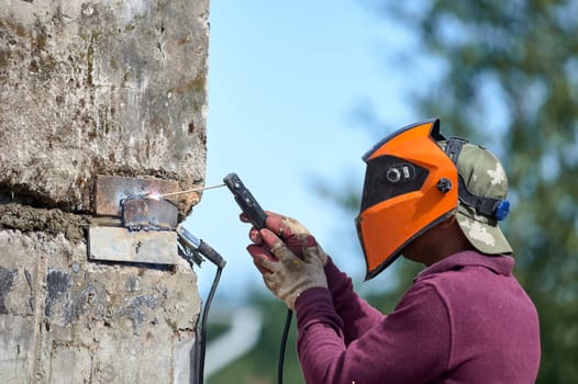 The welder welds reinforced concrete products together. High quality photo