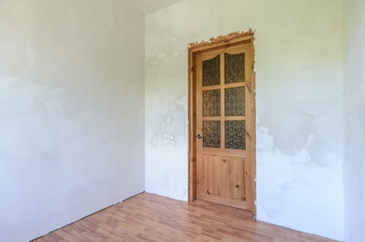 View of the front door in a small room after renovation