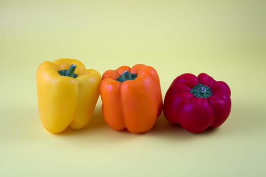 peppers yellow, orange and red, three vegetable fruits organic ingredients fresh vegetarian meal