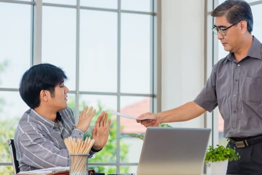 Asian businessman anti bribery and corruption he rejecting money in white envelope offered by partner. Business man sending resignation letter to employee the business downturn to laid off at office