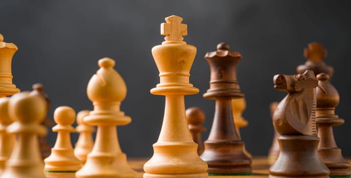 Chess pieces on a chessboard - Focus on the King