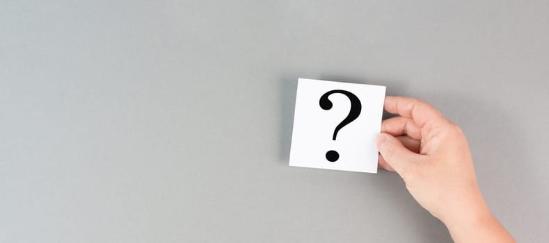 Question mark in the hand, looking for an answer, searching for knowledge, problem solving, business and education concept