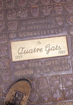 Barcelona, Spain - Dec 29th, 2019: Els Quatre Gats cafe. Winter visitor walking over ground plaque
