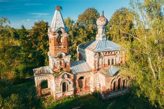 Martinovo, Beshenkovichsky District, Vitebsk Region, Belarus. Bird's-eye View Of Church Of The Intercession Of The Most Holy Theotokos. Aerial View Of Historic Landmark In Autumn Sunny Evening.