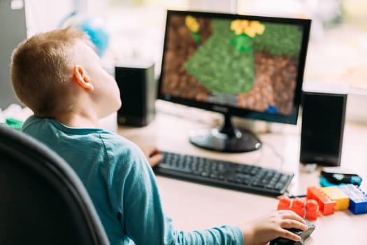 Little Caucasian Boy Playing In Computer Games.