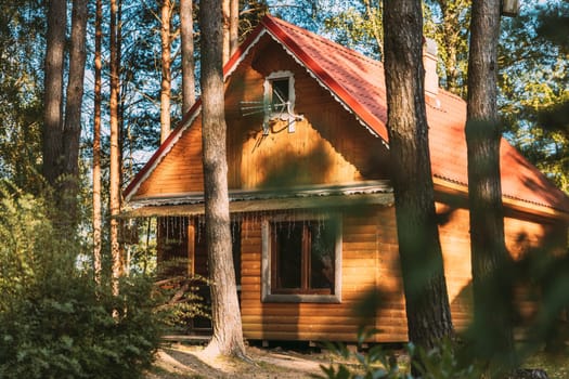 Tourist Guest House For Rest. Wooden House In Forest In Autumn Sunny Day.