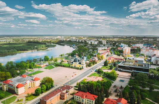 Rechytsa, Belarus. Aerial View Of Residential Houses And Famous Landmarks Of Town -  Holy Assumption Cathedral And Holy Trinity Church In Sunny Summer Day. Top View. Drone View. Bird's Eye View