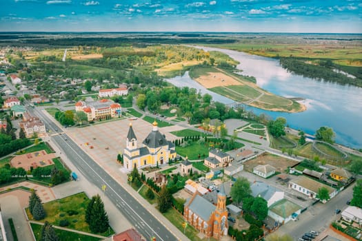 Rechytsa, Belarus. Aerial View Of Residential Houses, River Dnieper And Holy Assumption Cathedral In Sunny Summer Day. Top View. Drone View. Bird's Eye View.