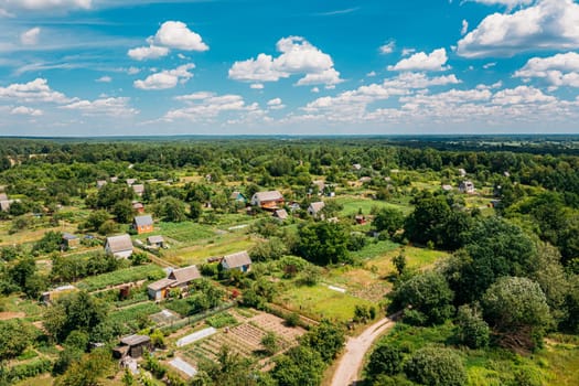 Aerial View Of Small Town, Village Cityscape Skyline In Summer Day. Residential District, Houses And Vegetable Garden Beds In Bird's-eye View.